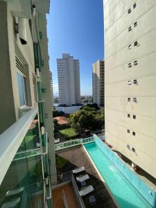 a view from the balcony of a building with a swimming pool at Atlantis by Mosaico Stays in Vitória