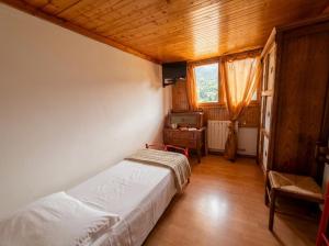 a bedroom with a bed and a tv in it at Garni Pirata in Cavareno