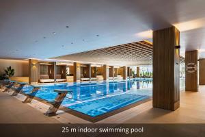 a large swimming pool in a hotel lobby at Pical Resort, Valamar Collection in Poreč