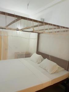 a bed in a room with a glass wall at Thalalla BnB in Talalla South +72 photos
