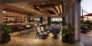 a restaurant with tables and chairs and a bar at InterContinental Indianapolis by IHG in Indianapolis