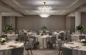 a banquet room with tables and chairs and a chandelier at InterContinental Indianapolis by IHG in Indianapolis