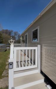 a front porch of a mobile home with a white fence at Kieras View At Bideford Bay in Bideford