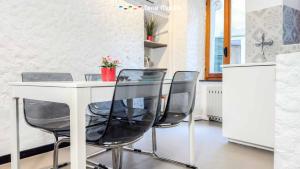 a kitchen with a table and four black chairs at La Grotta in Vernazza