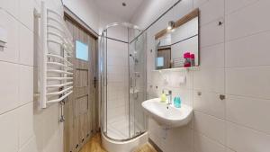 a white bathroom with a sink and a shower at Willa Mercedes in Gorzów Wielkopolski +39 photos