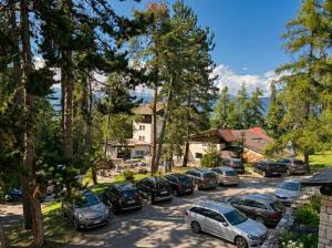 a group of cars parked in a parking lot at Garni Pirata in Cavareno