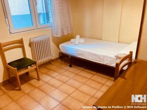 a small room with a bed and a chair at Amapola 1 in Soria