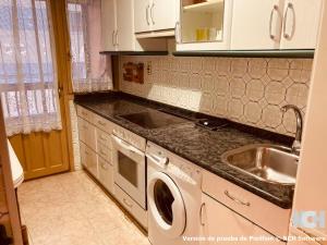 a kitchen with a washing machine and a sink at Amapola 1 in Soria
