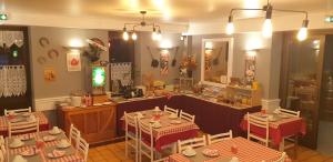 a restaurant with tables and chairs and a counter at Logis L'Auberge Bourbonnaise - Vichy sud in Saint-Yorre
