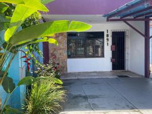 a front door of a house with plants at Açaizeiro Hostel in Belém