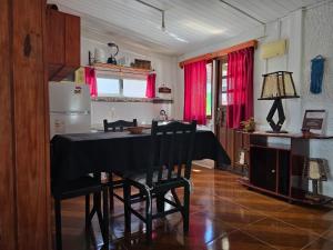 a kitchen with a table with chairs and a refrigerator at Maridalba 1 in La Coronilla +17 photos