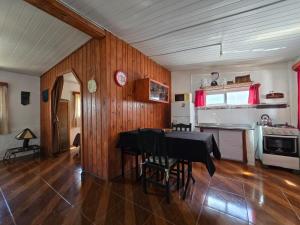 a dining room with a table and a kitchen at Maridalba 1 in La Coronilla
