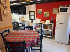 a kitchen with a table and a white refrigerator at Apartments Tedeschi in Korčula