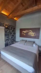 a bedroom with a large bed with a sign on the wall at Refúgio dos Capelinhos - Villa e Suites in Norte Pequeno +114 photos