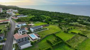 an aerial view of a house on a hill at Refúgio dos Capelinhos - Villa e Suites in Norte Pequeno