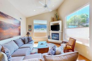 a living room with a couch and a fireplace at Rim Village O3 in Moab