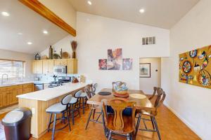 a kitchen with a wooden table and chairs and a counter at Rim Village O3 in Moab