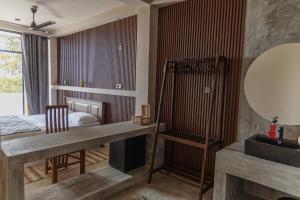 a bedroom with a bed and a desk and a mirror at Surf's Up LOFT in Weligama