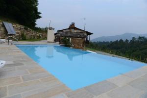 a swimming pool in a villa with mountains in the background at Sere di Sosta in Bagnolo Piemonte