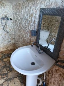 a white sink in a bathroom with a mirror at Diar twins in Gabès