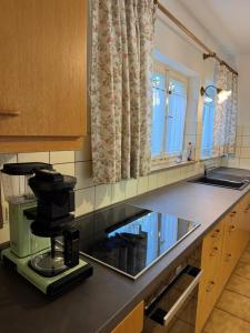 a kitchen with a coffee maker on a counter at Greenhouse in Fellbach +20 photos