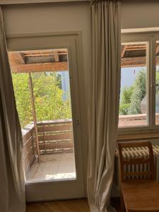 a room with a sliding glass door with a window at Greenhouse in Fellbach