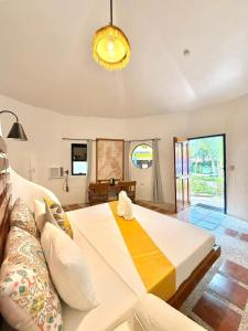 a bedroom with a large bed and a chandelier at Stone Manor Inn in Concepcion