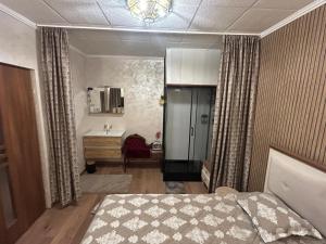 a bedroom with a bed and a sink in it at Appartement in Oberschaeffolsheim