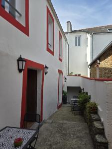 a patio with a table and chairs next to a building at Hotel Saint Amant in Le Palais