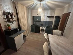a small kitchen with a table and a washing machine at Appartement in Oberschaeffolsheim
