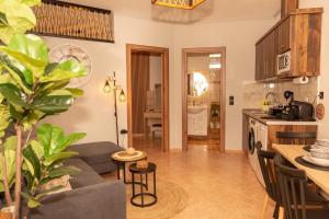 a kitchen and living room with a couch and a table at F Tsimas apartment 1 in Skala Potamias