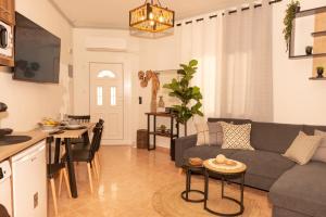a living room with a couch and a table at F Tsimas apartment 1 in Skala Potamias