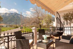 a patio with chairs and tables and a fence at F Tsimas apartment 1 in Skala Potamias