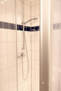 a shower with a shower head in a bathroom at Hotel Eifeltor in Mechernich