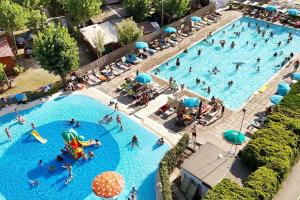 an overhead view of a large swimming pool with people in it at La Dolce 1 in Lido di Dante