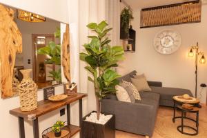 a living room with a couch and a plant at F Tsimas apartment 1 in Skala Potamias