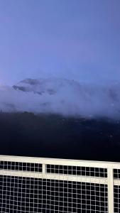 a view from the top of a building with clouds at Sanhill & Oasis in Ranau