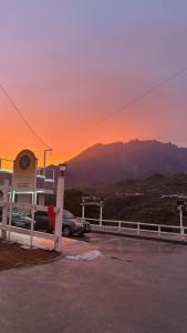 a parking lot at a gas station with a sunset at Sanhill & Oasis in Ranau