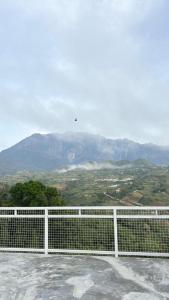 a white fence with a view of a mountain at Sanhill & Oasis in Ranau +29 photos