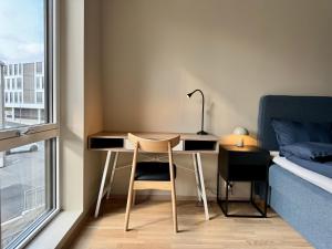 a bedroom with a desk and a bed and a desk and a chair at Apartment by Kokstad tram in Bergen