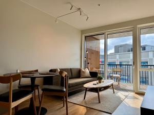 a living room with a couch and a table at Apartment by Kokstad tram in Bergen