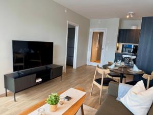 a living room with a couch and a table at Apartment by Kokstad tram in Bergen