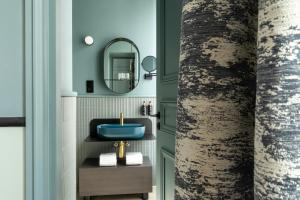 a bathroom with a blue sink and a mirror at Hôtel le 6 Tiquetonne in Paris +92 photos
