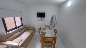 a living room with a couch and a table at Arena Studio Mar de Ajó in Mar de Ajó