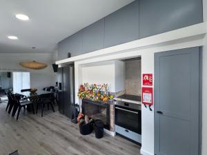 a kitchen with a fireplace and a dining room at Á-do-Couve in Alvito