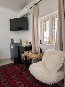 a living room with a white chair and a table at French Bistro Studio in Johannesburg