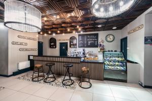 a restaurant with two stools and a counter with a bakery at Rest Up London in London