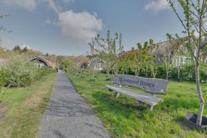 a park with a bench next to a path at 't Landgoed Baars in Baars