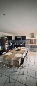 a large kitchen with a large table and chairs at Gîte Côte et Terre in Questrecques +38 photos