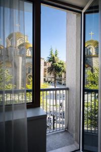 an open window with a view of a church at Hotel Turist - City Center in Skopje